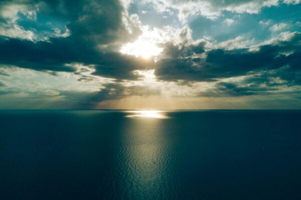 ocean under crepuscular clouds