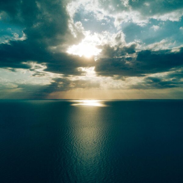 ocean under crepuscular clouds